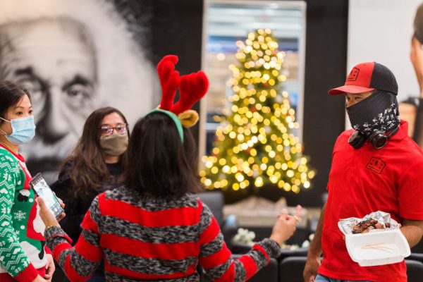 people standing around talking at holiday part